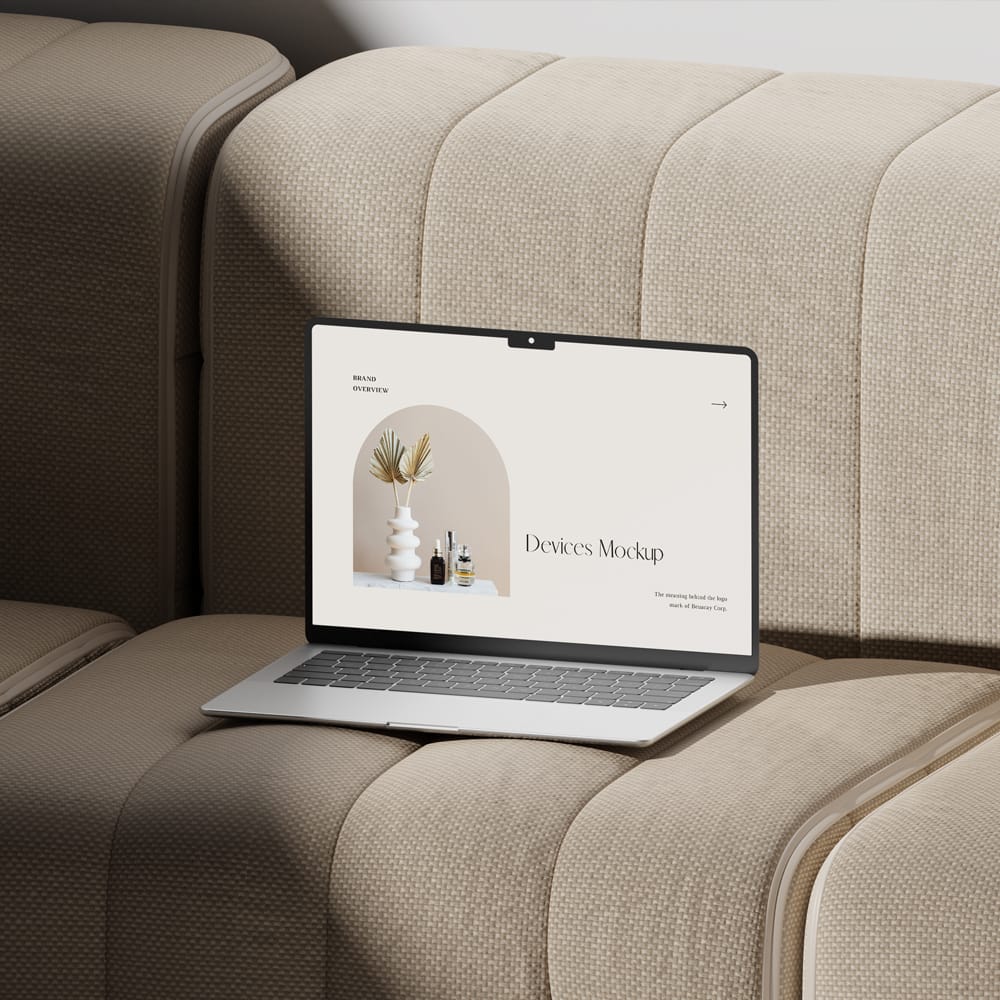 Free MacBook Pro on Sofa Mockup PSD