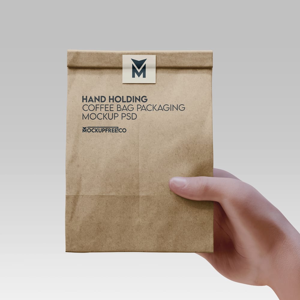 Free Hand Holding Coffee Bag Mockup PSD