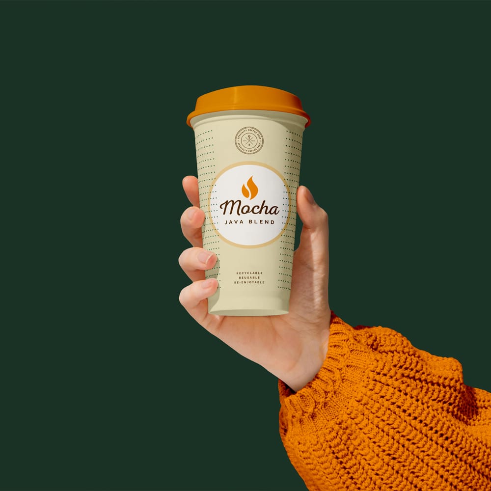 Free Realistic Hand Holding Coffee Cup Mockup PSD