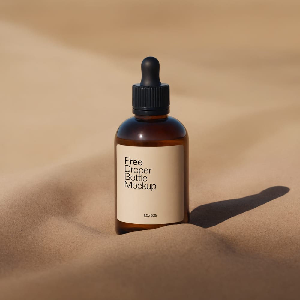 Free Amber Dropper Bottle Mockup with Sand Background PSD