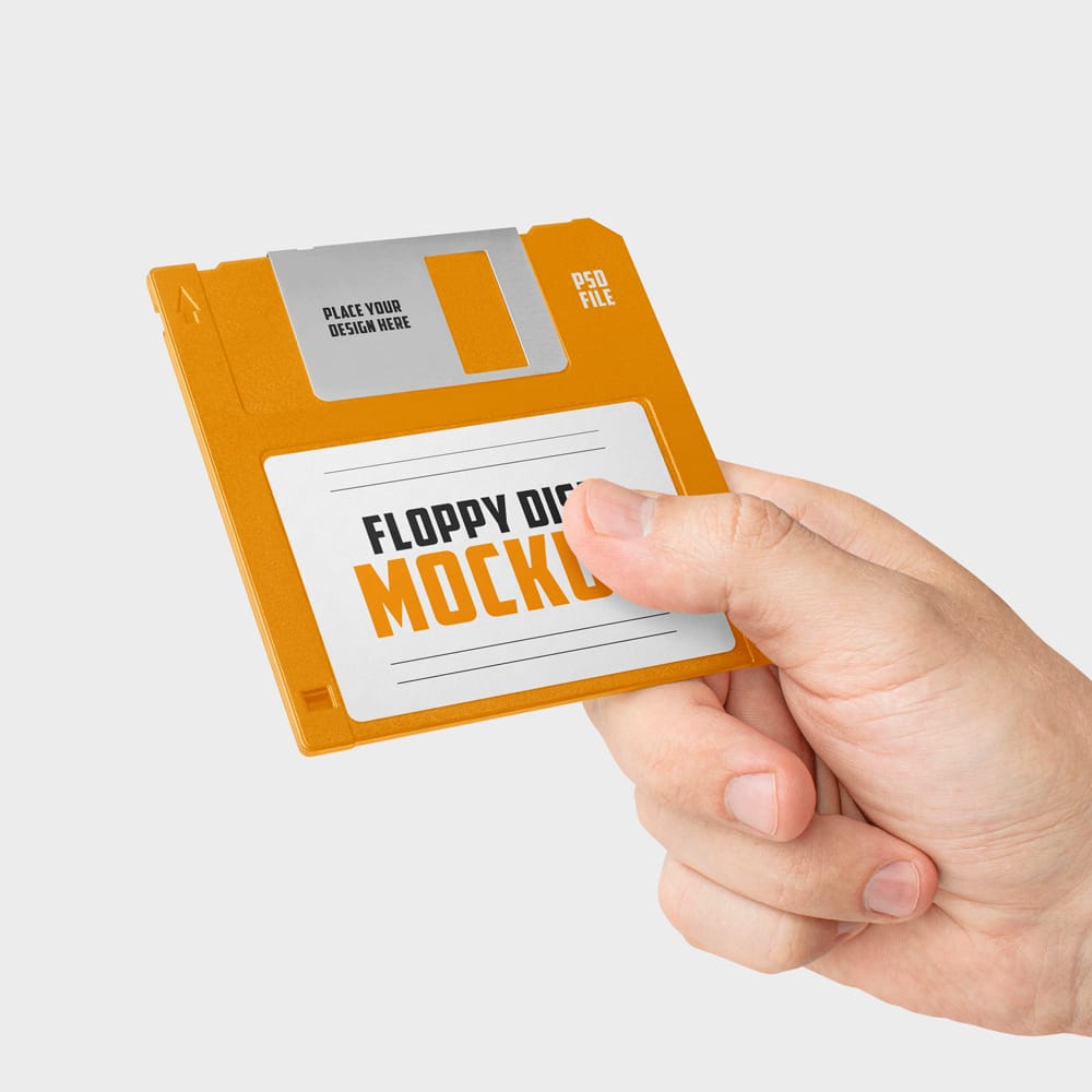 Free Hand Holding Floppy Disk Mockup PSD