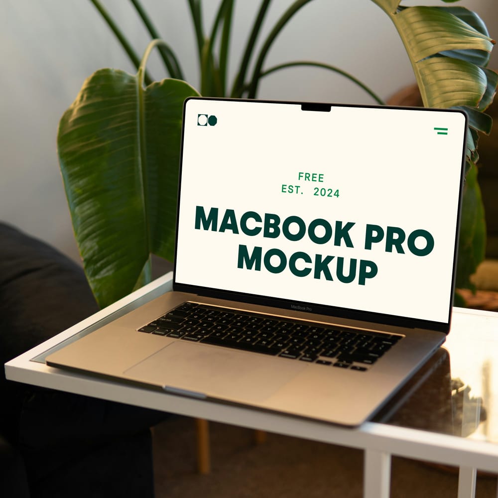 Free MacBook Pro on Small Table Mockup PSD