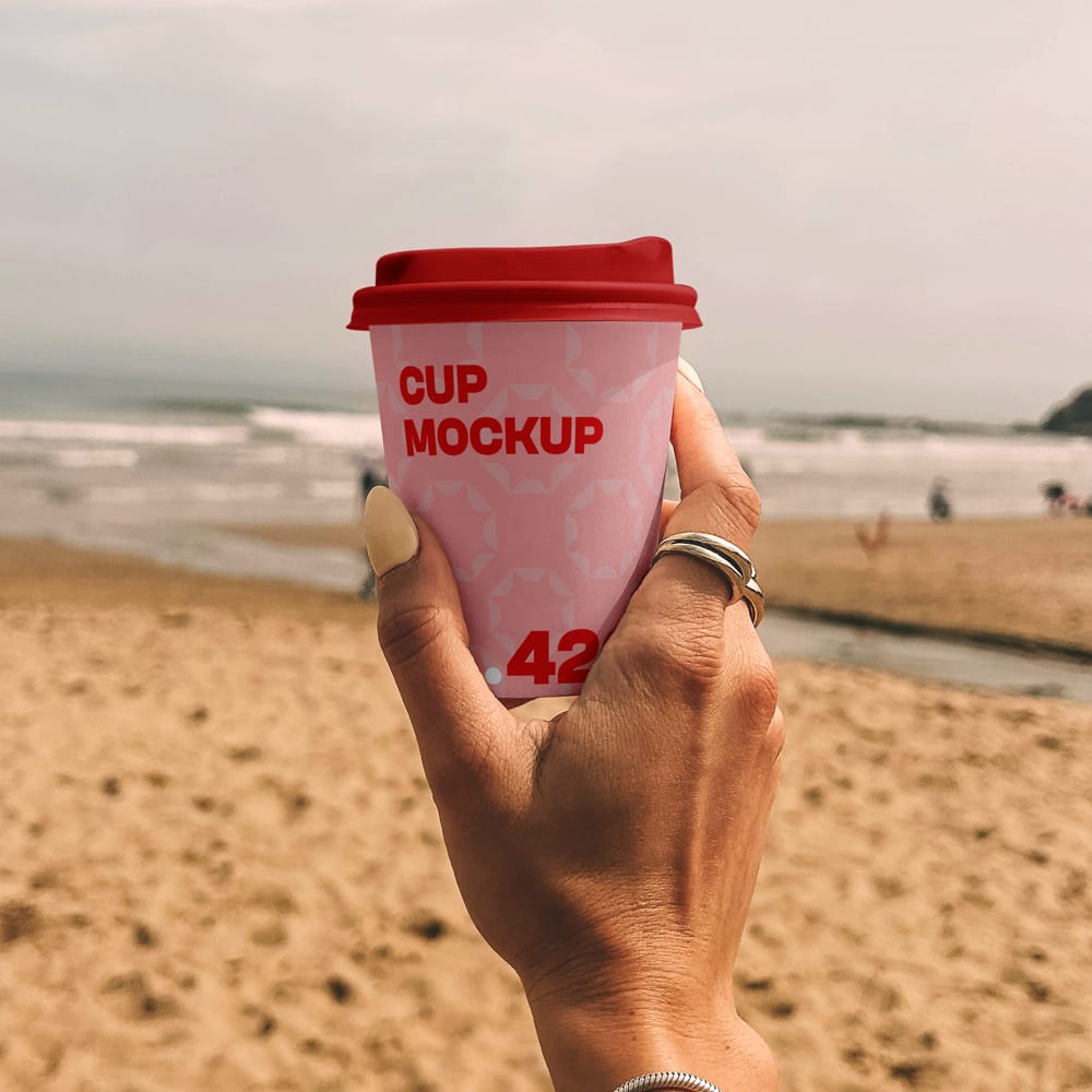 Free Paper Coffee Cup on the Beach Mockup PSD