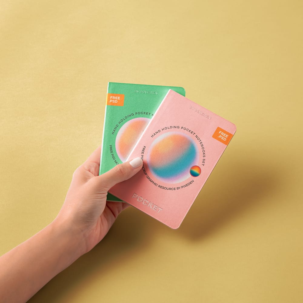 Free Hand Holding Pocket Notebooks Set Mockup PSD