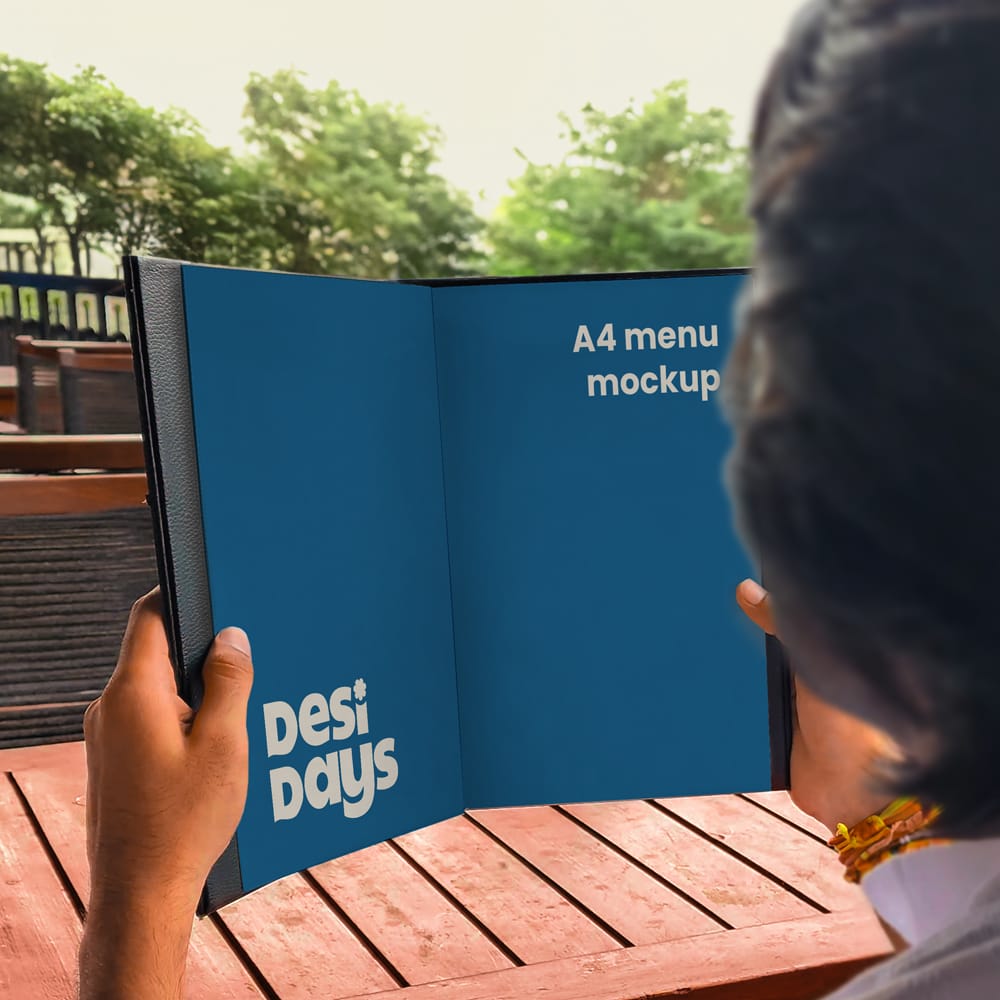 Free Man Holding a Menu Mockup PSD