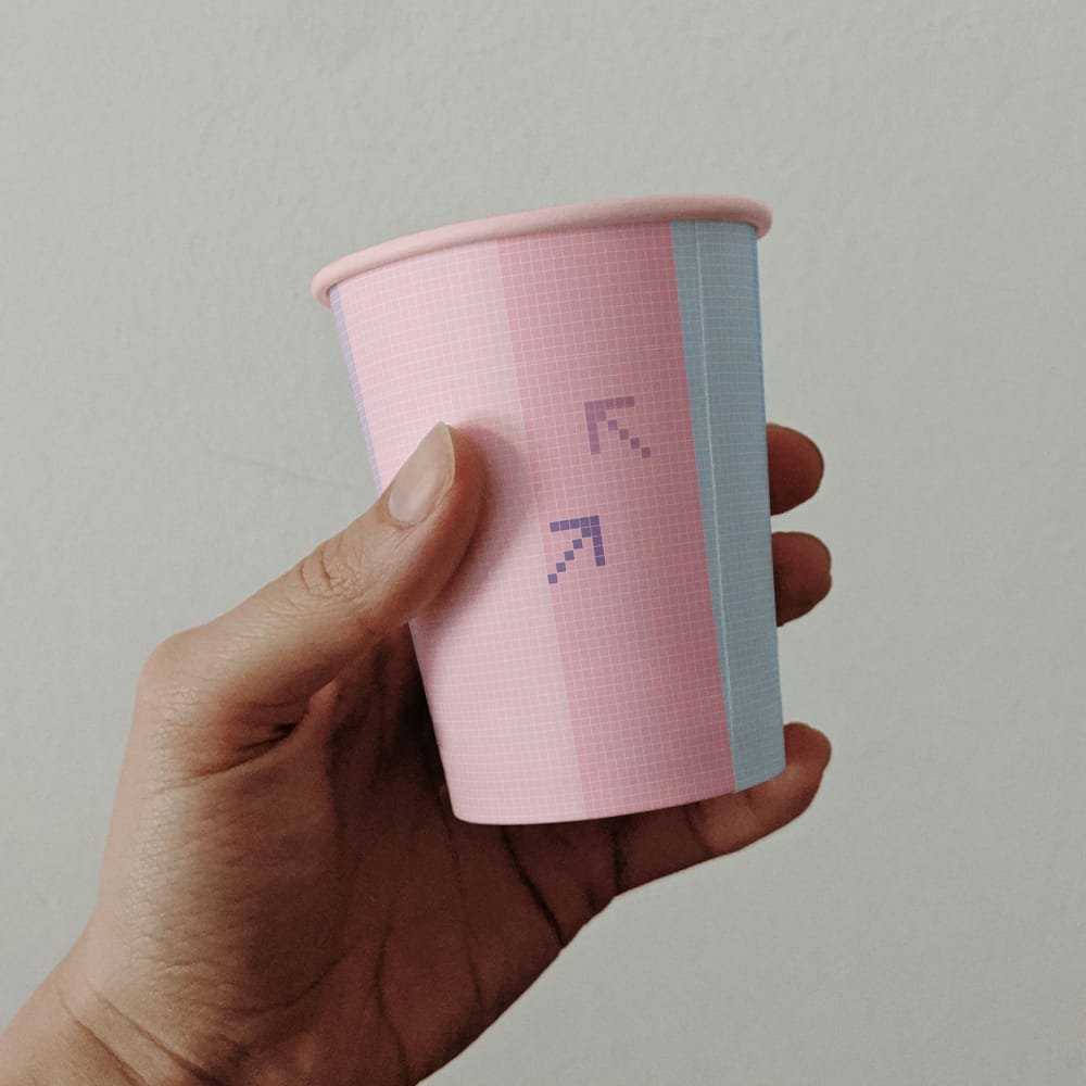 Free Paper Cup Held by Hand Mockup PSD