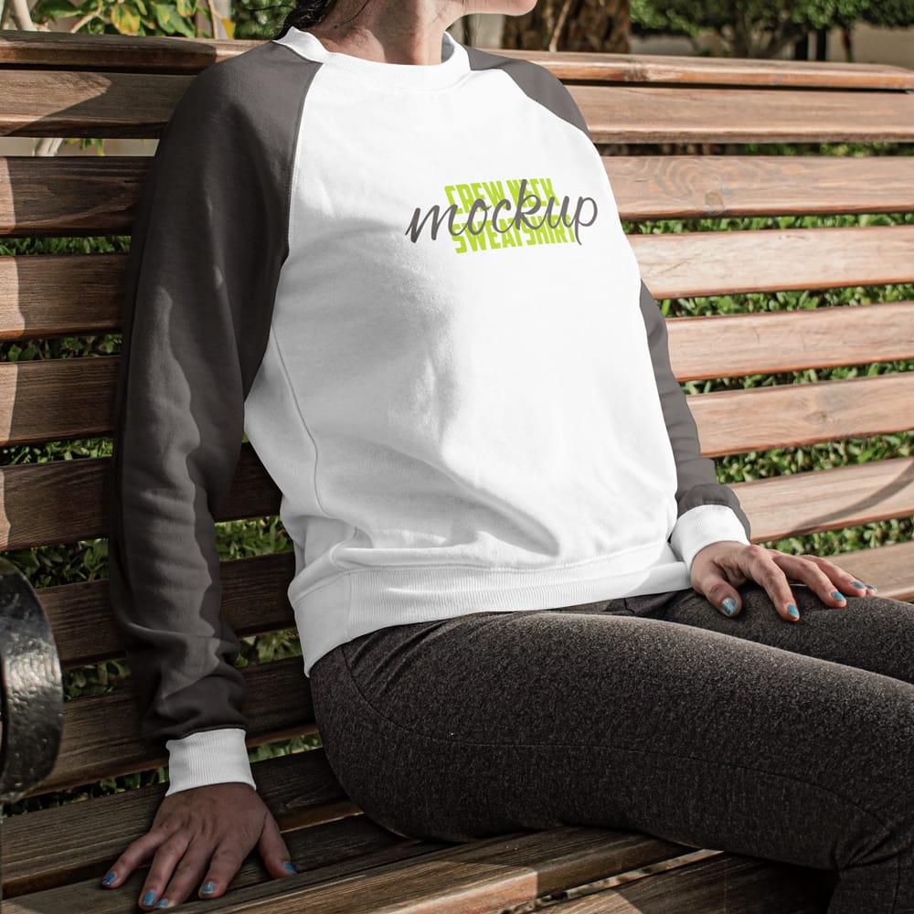 Free Woman Sitting on a Bench Wearing a Crew Neck Sweatshirt Mockup PSD