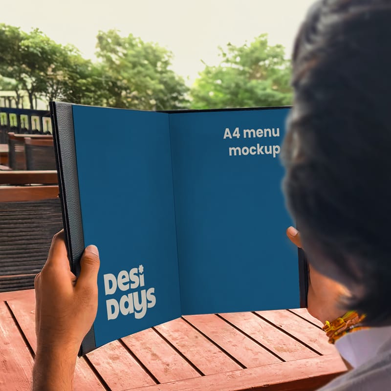 Man Holding a Menu Mockup PSD