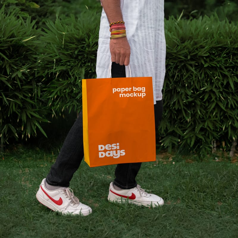 Man with a Paper Bag Mockup in the Grass PSD