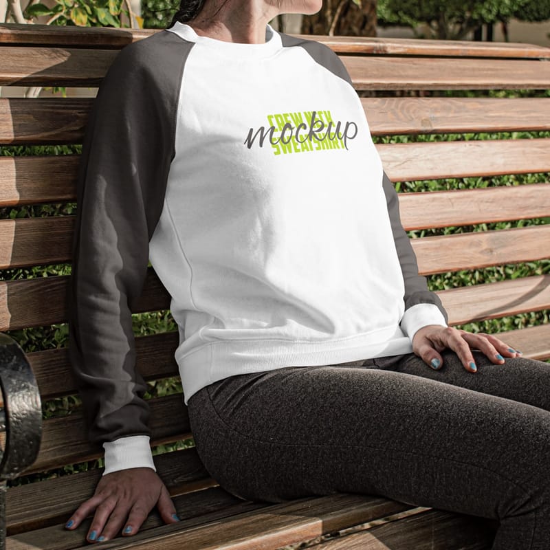 Woman Sitting on a Bench Wearing a Crew Neck Sweatshirt Mockup PSD