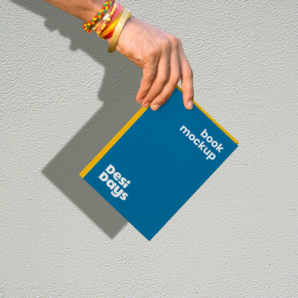 Free Hand Holding Book with Shadow Mockup PSD