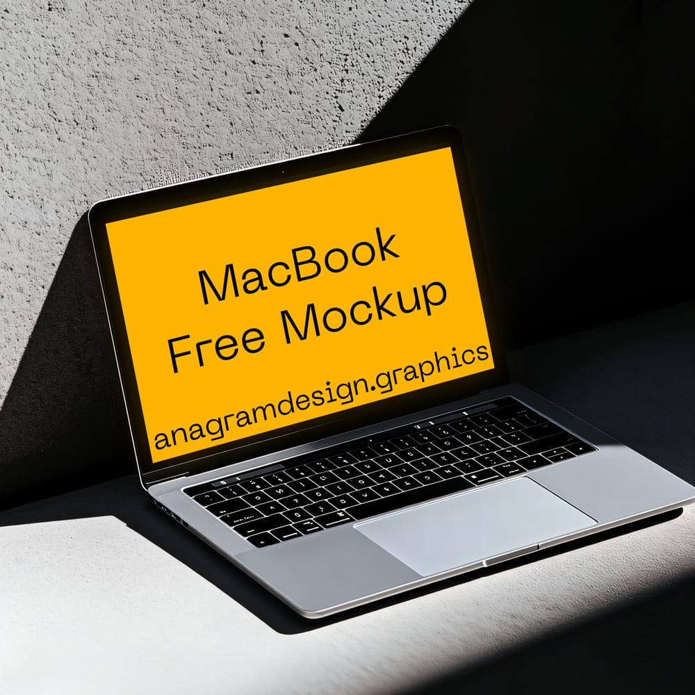 Free MacBook Mockup on a Concret Wall PSD