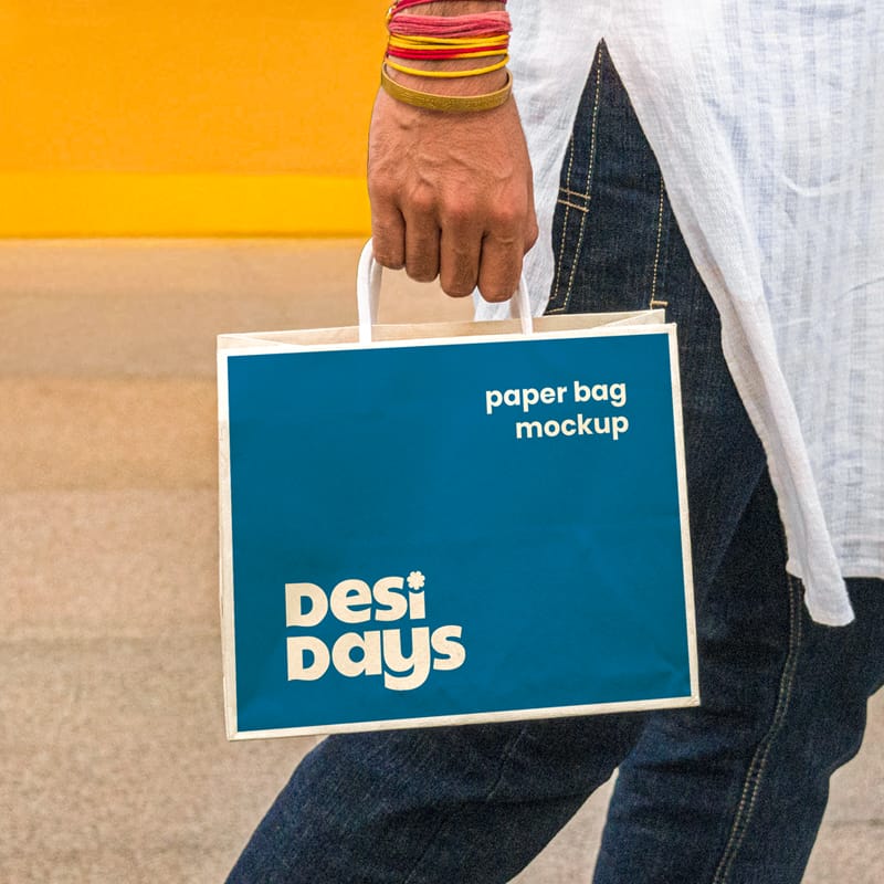 Man Holding a Paper Bag Mockup PSD