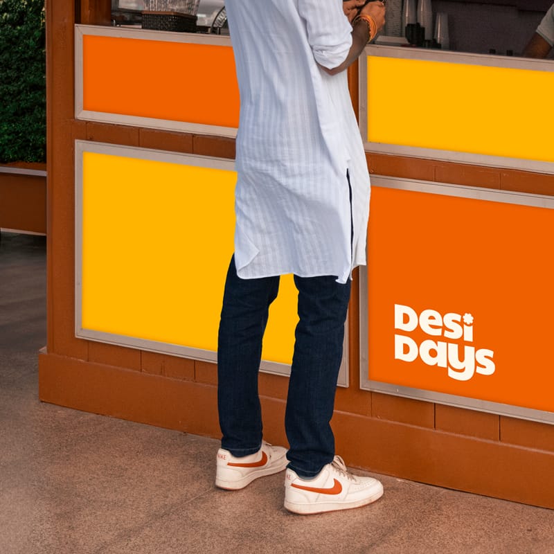Man in Kurta Standing at a Kiosk Mockup PSD