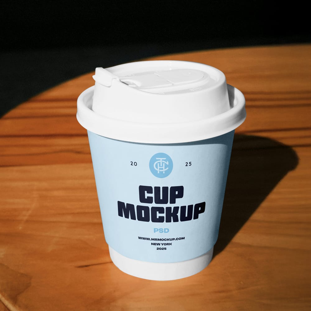 Free Coffee Cup on a Table Mockup PSD