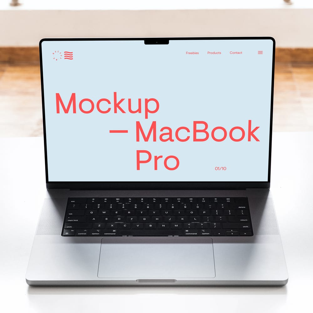 Free MacBook Pro on White Table Mockup PSD