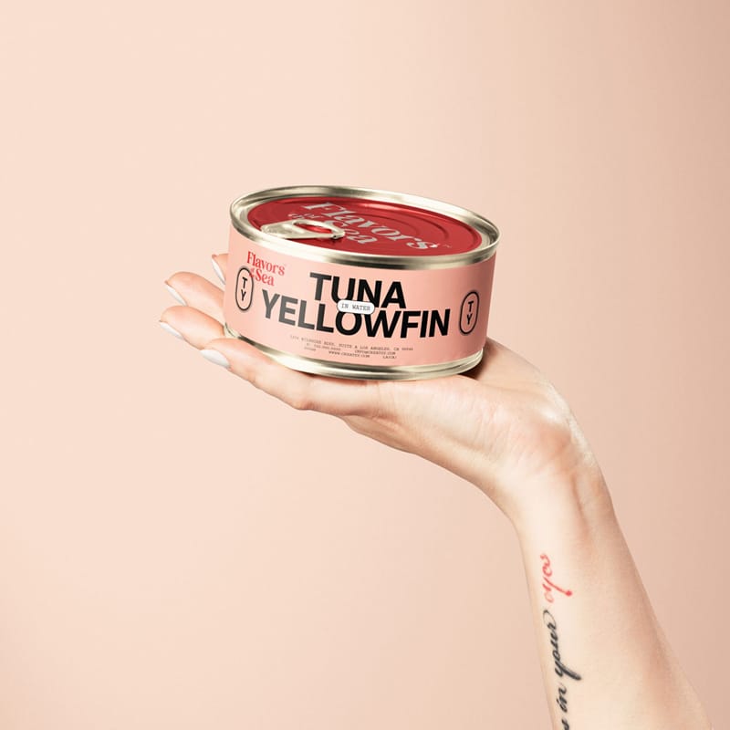 Short Flat Tin Can in Hand Packaging Mockup PSD