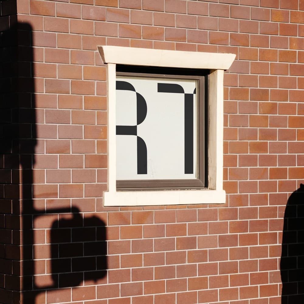 Free Realistic Urban Window Poster Mockup on Brick Wall PSD