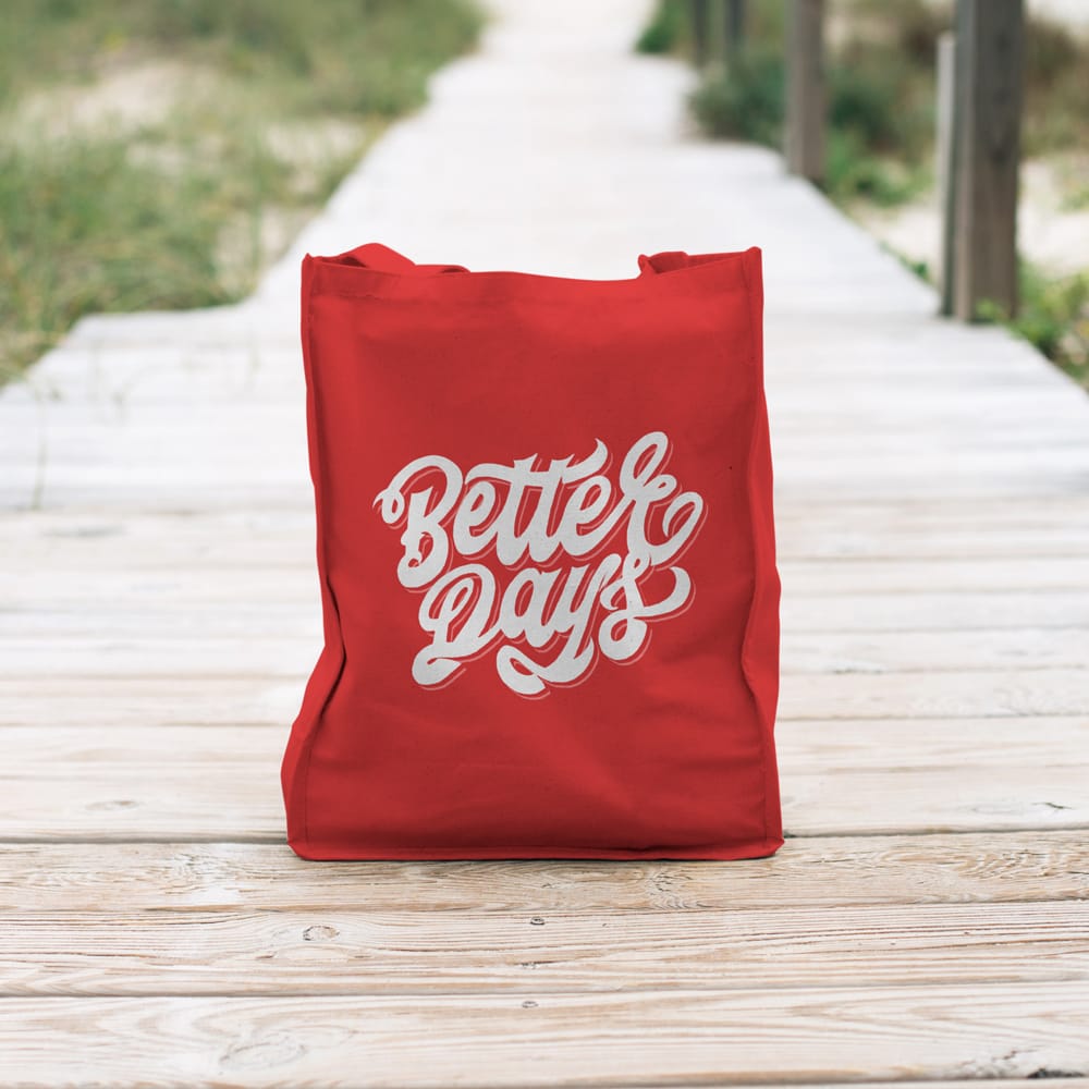 Free Red Canvas Tote Bag Mockup on Boardwalk PSD
