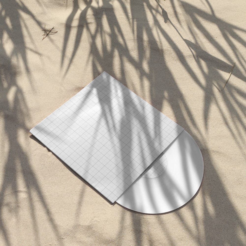 Free Vinyl Record Album Placed on Smooth Sand Mockup PSD