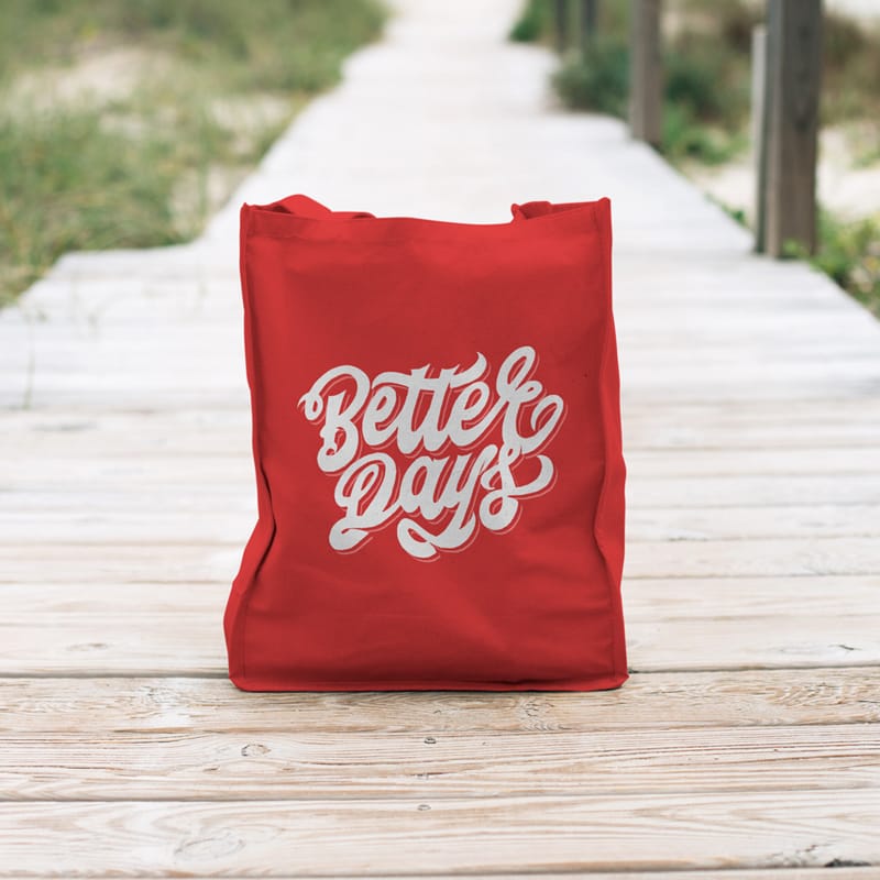 Red Canvas Tote Bag Mockup on Boardwalk PSD