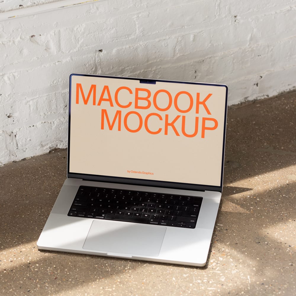 Free Macbook Pro Mockup on Concrete Studio Floor PSD